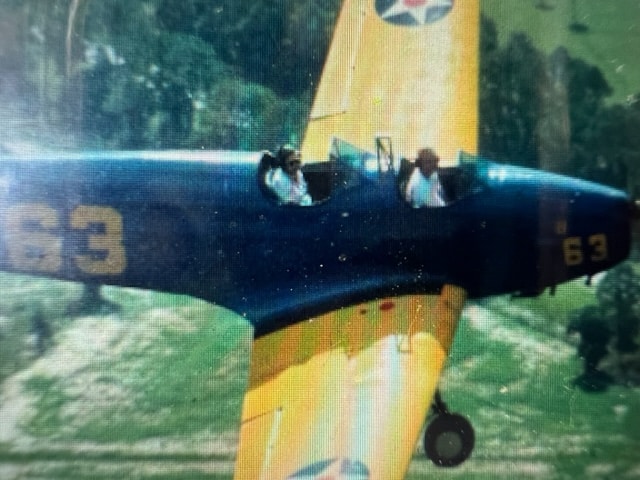 Charlie Bausch piloting Grandma Bausch in vintage plane